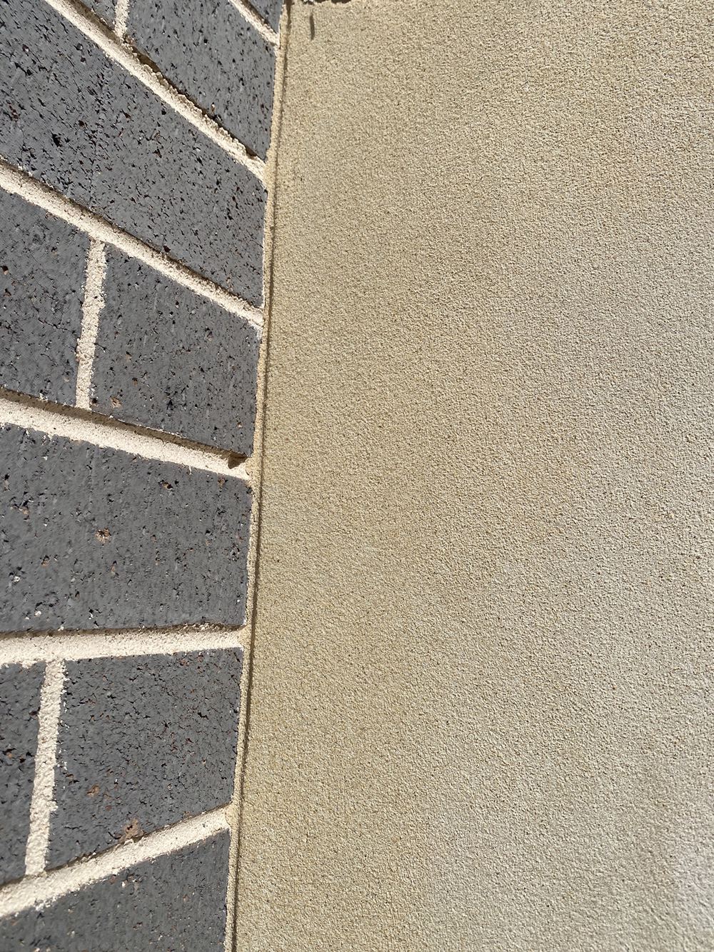 Render applied straight over a control joint, which will crack along that line, Gables