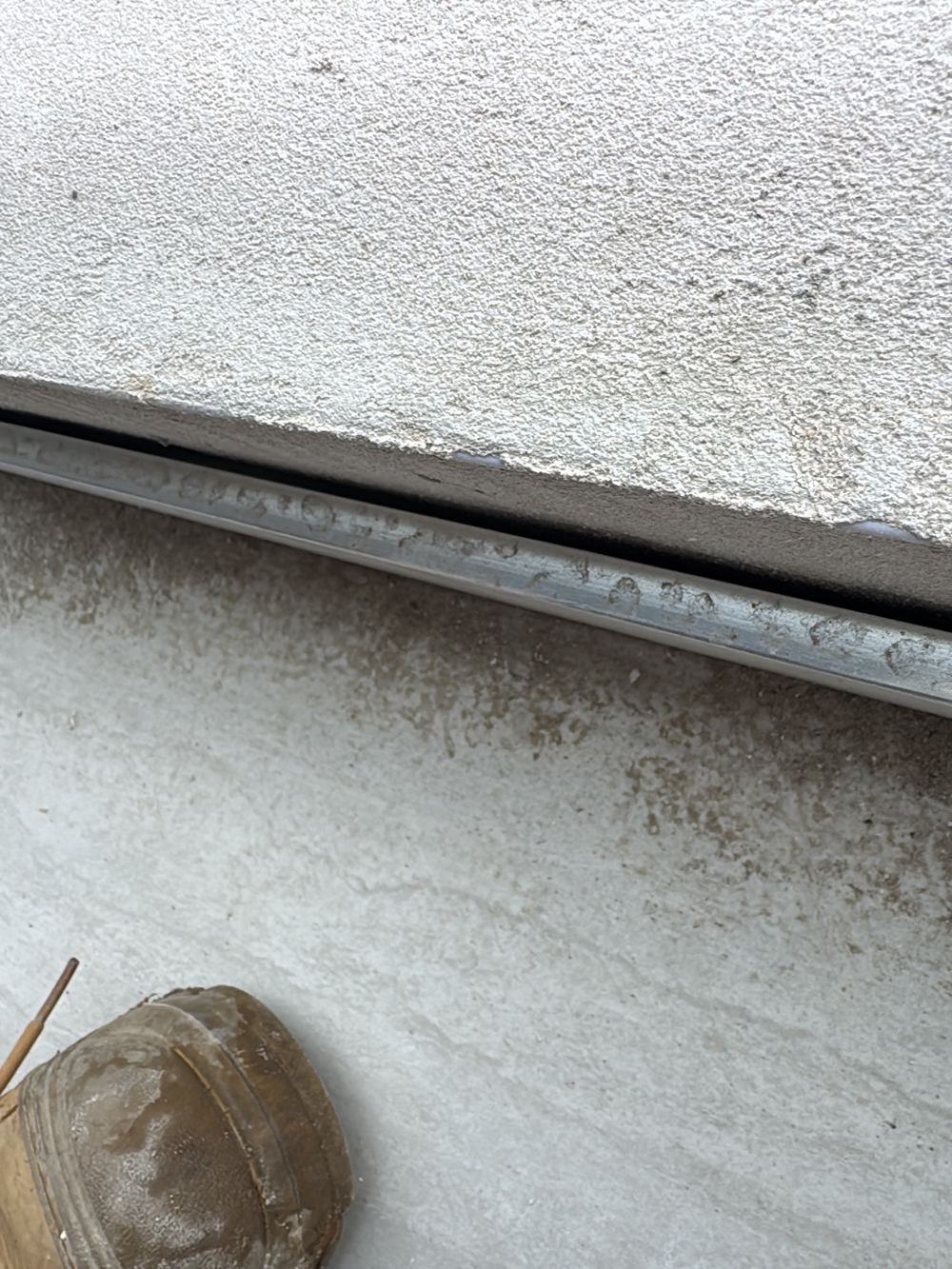 Hollow balcony tiles laid on dabs of adhesive instead of a full bed, found during a handover inspection in Gables