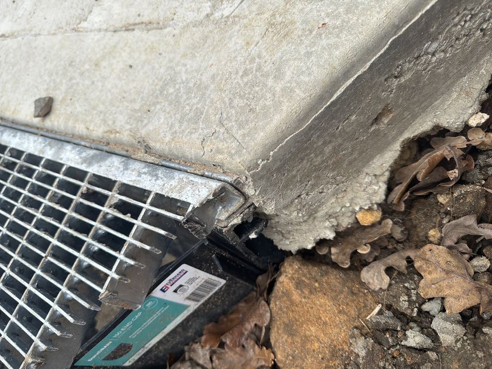 Spoon drain butted to the driveway without a movement joint, recorded during a defect investigation in Ermington