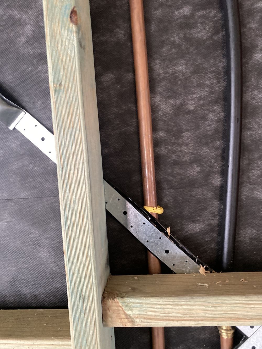 Gas pipe touching metal framing with no separation fitted between them, found during a lock-up inspection in Gables